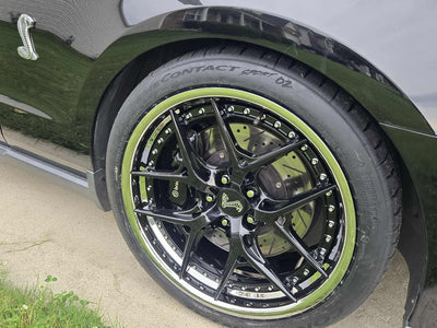 2011 Ford Shelby GT500 with custom forged black and chrome RVRN RV-DR08D series wheels close-up.