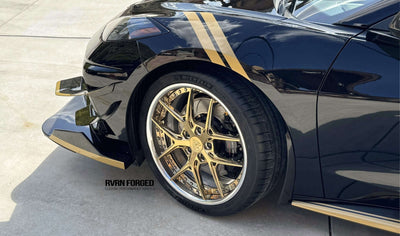 Close-up of 2020 Corvette C8 Z51 with corvette gold rims and RVRN aftermarket wheels on a sleek black exterior.