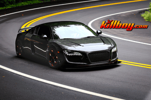 Front three-quarter view of a black 2008 Audi R8 on RVRN RV-DS016 forged wheels with gloss black gradient red spokes on a mountain road