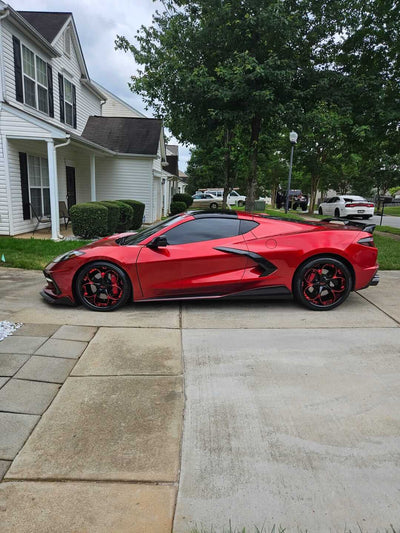 Red Corvette parked in driveway showcasing custom RVRN forged wheels, part of the RVRN Vehicle Gallery.