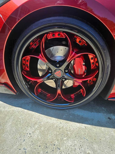 Close-up of RVRN custom forged wheels with a striking red finish on a vehicle in the RVRN Vehicle Gallery.