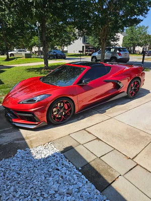 Red Corvette C8 featuring sleek custom RVRN Forged Wheels in a residential setting.