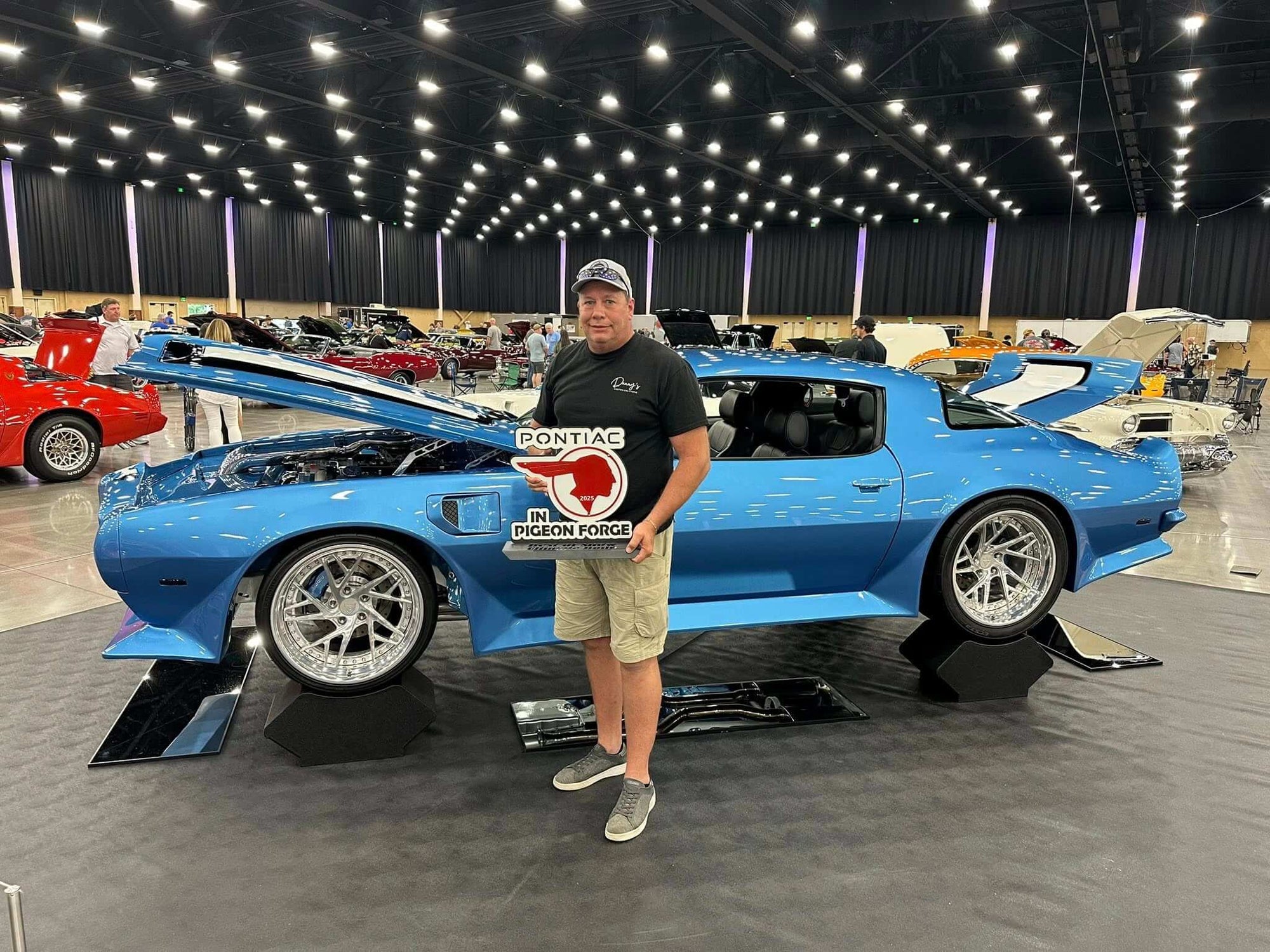 RVRN Wheels customers showcase custom forged wheels at a car show with a blue Pontiac and proud owner.