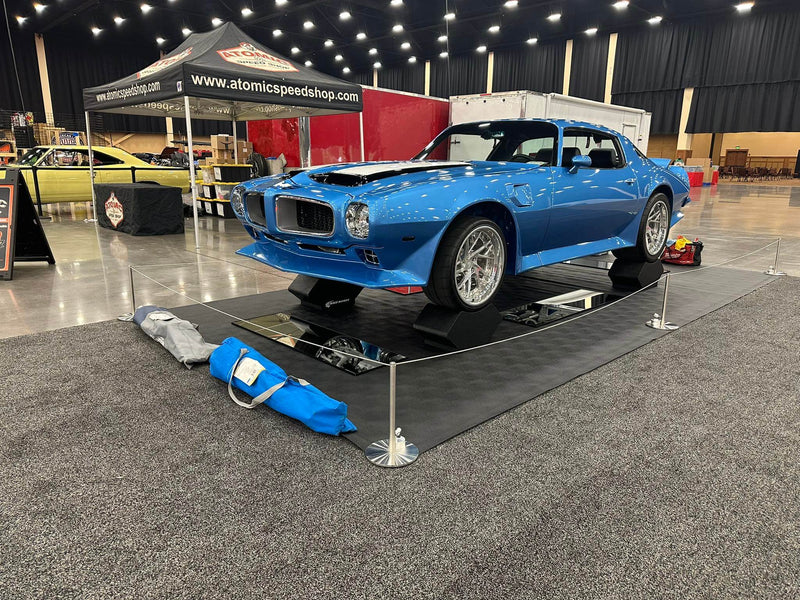 1973 Pontiac Trans Am on display with custom forged wheels and super deep dish rims at a car show.