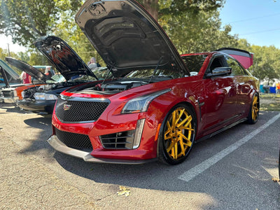 Cadillac CTS-V showcasing RVRN Forged 22-inch custom wheels and luxury performance features in a sunny car show.