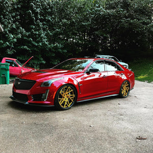 Red Cadillac CTS-V with custom RVRN Forged 22-inch deep dish luxury performance wheels parked on a driveway.