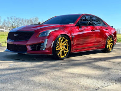 Cadillac CTS-V with luxurious gold RVRN Forged 22-inch deep dish custom wheels, showcasing high-performance forged rims.