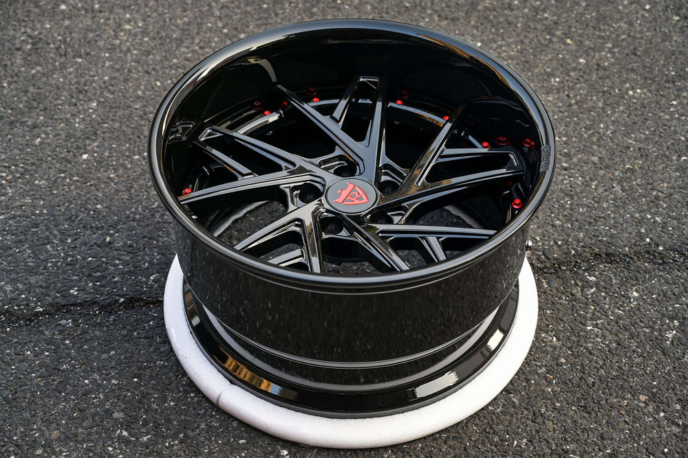 Custom black deep dish rims for Subaru STi, featuring a sleek design and red accents.
