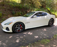 2018 Maserati Granturismo with custom 20-inch staggered RVRN forged RV-DV03 Series wheels on a scenic road.