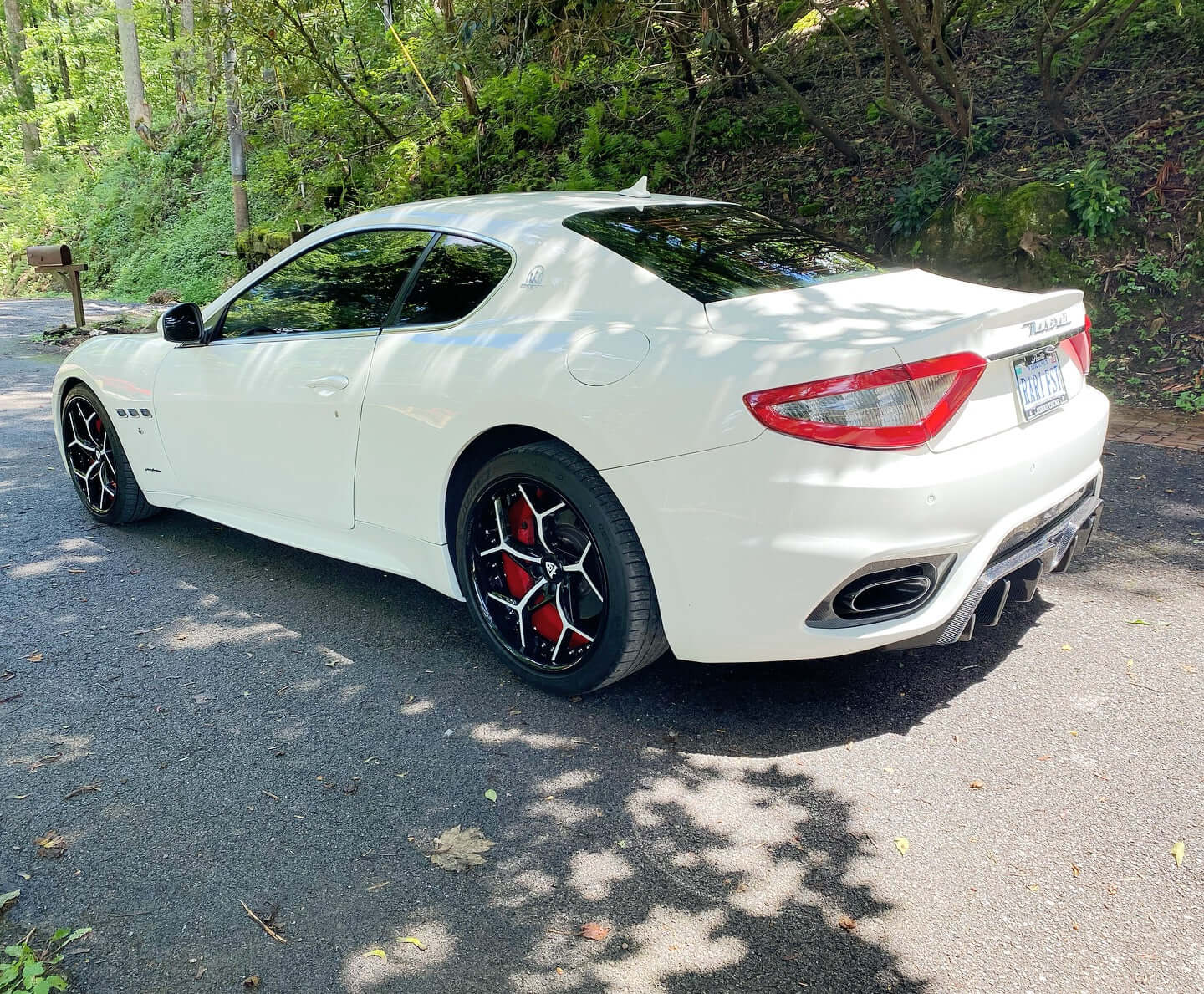 2018 Maserati Granturismo with custom 20-inch staggered RVRN forged RV-DV03 Series wheels on a scenic road.