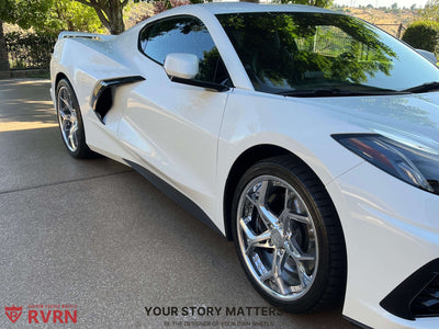 White Corvette C8 showcasing polished aluminum aftermarket wheels in bright daylight.