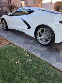 Corvette C8 showcased with polished aluminum wheels, highlighting aftermarket customization and sleek design.