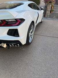Corvette C8 featuring polished aluminum wheels in a serene driveway setting, showcasing aftermarket customization.
