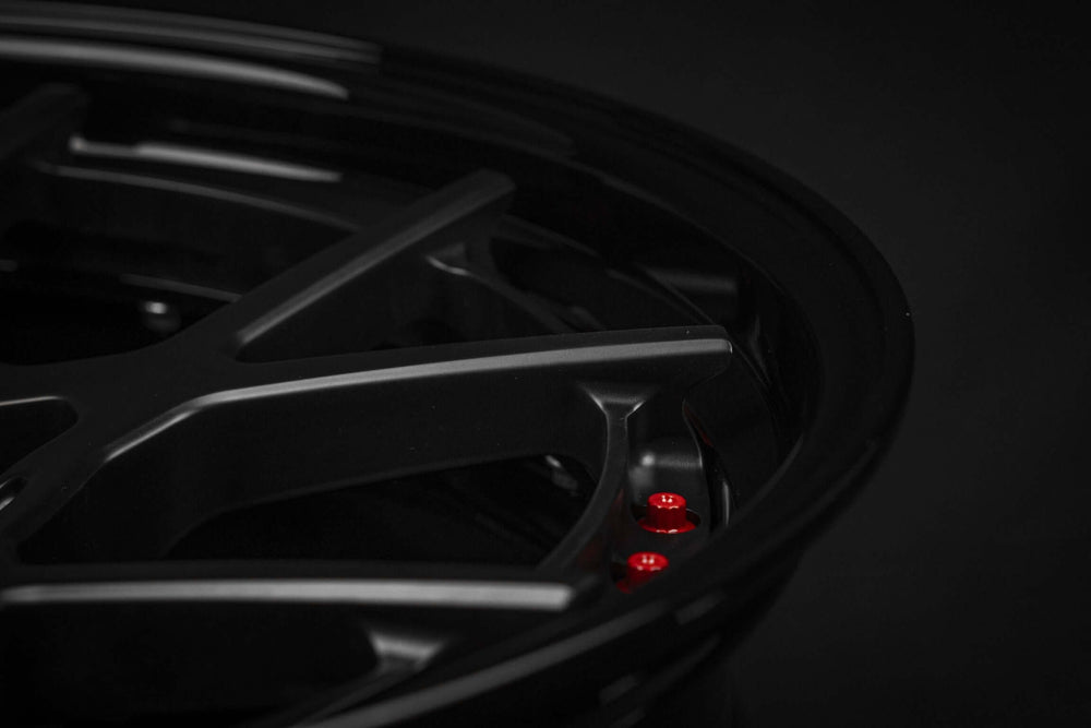 Close-up of custom forged black and red RVRN Wheels RV-DF02 for Ford Mustang GT