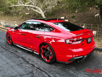 2019 Audi RS5 in red with black 20x9 RVRN custom forged wheels parked on a scenic road.