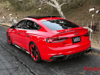 2019 Audi RS5 in red with black custom 20x9 RVRN forged wheels parked on a scenic road.