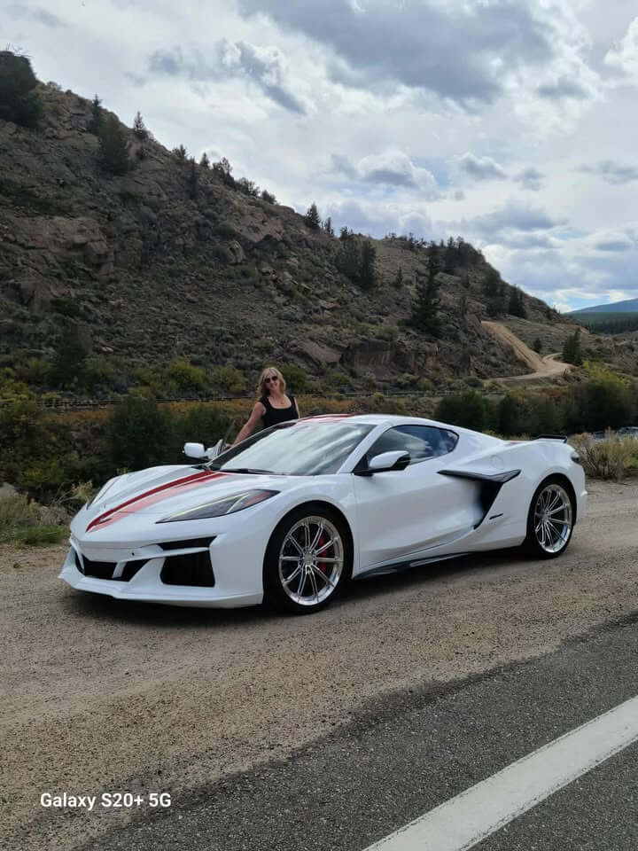 2025 Corvette C8 E-Ray with polished aluminum custom wheels parked on a driveway, showcasing forged performance rims.