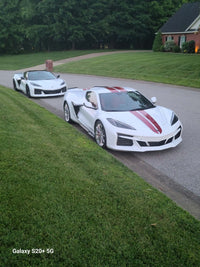 2025 Corvette C8 E-Ray with polished aluminum custom wheels parked on a residential street.