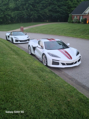 2025 Corvette C8 E-Ray with polished aluminum custom wheels parked on a residential street.