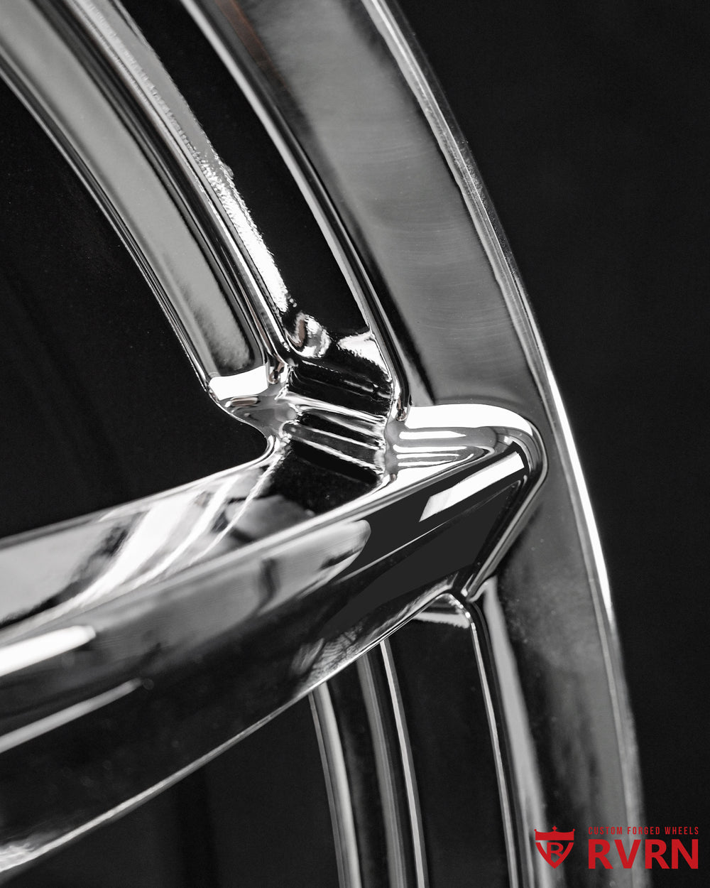 Close-up of a 5 spoke chrome rim for Porsche 911, showcasing its detailed finish and design.