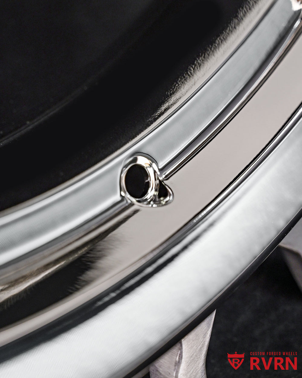 Close-up of aftermarket Porsche 911 5 spoke chrome rim, showcasing intricate details and perfect shine.