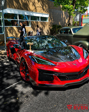 Front view of a red 2025 Corvette C8 Z06 3LZ Z07 on RVRN RV-MC35 5-spoke wheels with gloss black spokes and red mist barrels