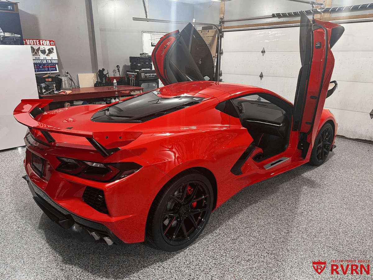 2021 Corvette C8 Z51 in vibrant red, showcasing aftermarket RVRN red and black wheels in a garage setting.
