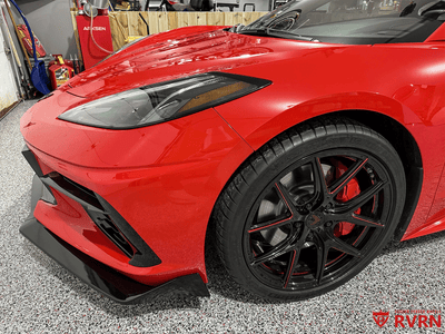 2021 Corvette C8 Z51 with red and black RVRN aftermarket wheels in a garage setting.