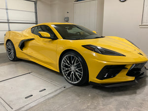Front three-quarter view of a yellow 2026 Corvette C8 LT1 Coupe on RVRN RV-MC65 all-chrome concave wheels inside a garage