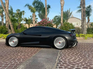 Side profile of a satin black 2017 Audi R8 on RVRN RV-MD02 brushed aluminum forged wheels, parked on a brick driveway