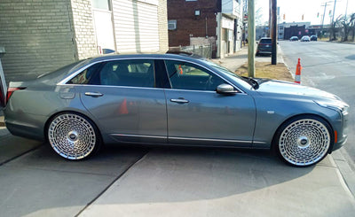Cadillac CT6 with custom brushed aluminum forged wheels and floating center caps, showcasing luxury 24 inch rims.