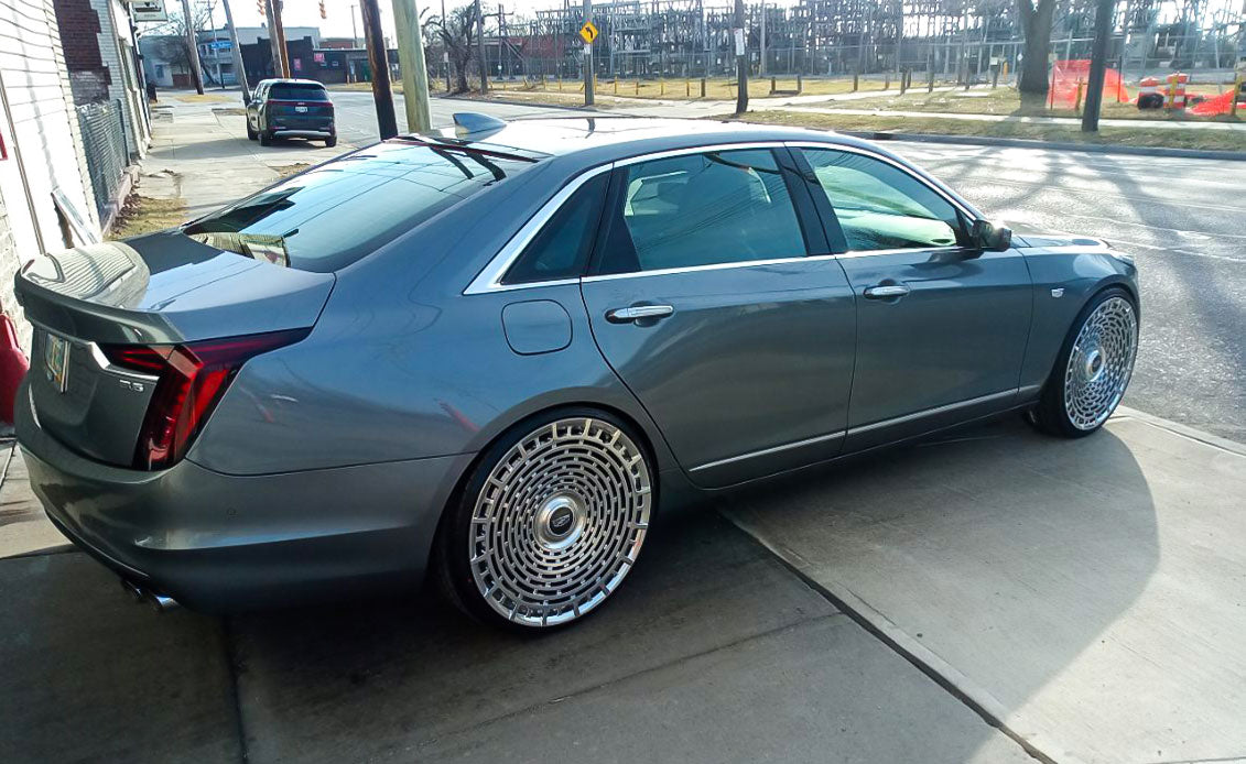 Cadillac CT6 with custom brushed aluminum forged wheels, showcasing luxury 24-inch rims and floating center caps.