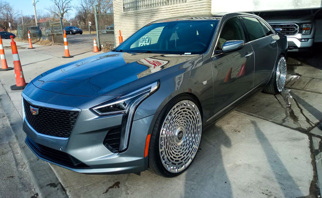 Cadillac CT6 with custom brushed aluminum forged wheels, showcasing luxury 24 inch rims and floating center caps.