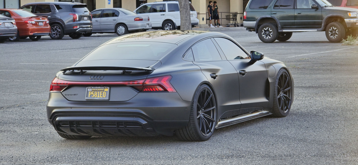 2022 Audi E-Tron GT with super concave custom forged wheels parked in a lot.