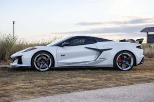 2023 Corvette C8 Z06 with custom carbon flash concave rims showcased on a scenic background.