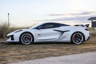 2023 Corvette C8 Z06 with custom carbon flash concave rims showcased on a scenic background.