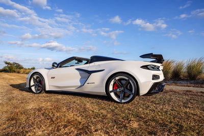 2023 Corvette C8 Z06 with custom carbon flash wheels and concave design against a scenic backdrop.