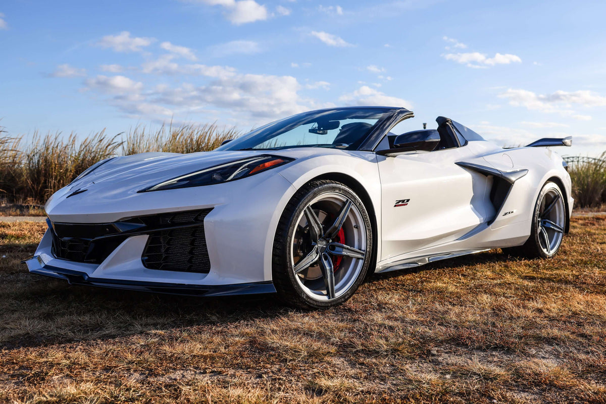 2023 Corvette C8 Z06 with custom carbon flash wheels and concave rims on a sunny day.