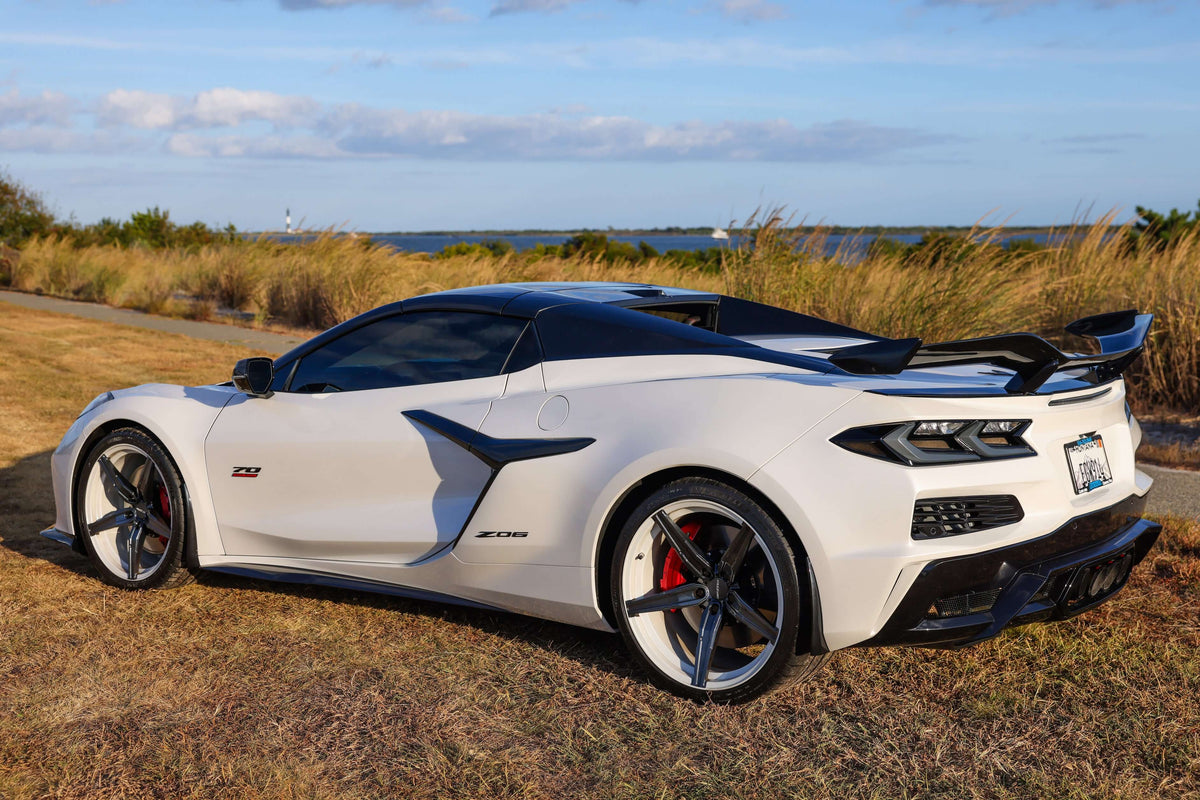 2023 Corvette C8 Z06 with custom concave carbon flash wheels on a scenic background.