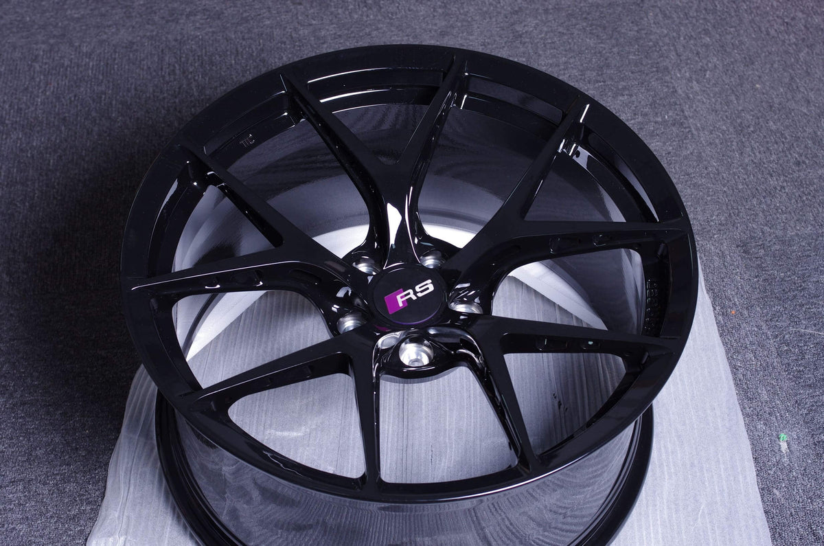 Audi RS4 aftermarket ultra-lightweight forged monoblock black performance wheel on a display background.