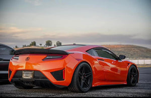 Rear three-quarter view of an orange 2019 Acura NSX on RVRN RV-MR02 gloss black custom forged wheels parked at dusk