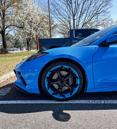 Side view of 2024 Corvette C8 Stingray equipped with MS016 custom forged wheels in Rapid Blue and black, showing aggressive stance and precise fitment.
