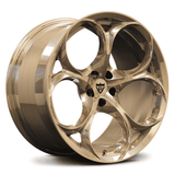 Custom forged 1-piece monoblock wheel, designed for Alfa Romeo Giulia, featuring a unique gold finish and aerodynamic style.