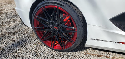 Side view of Corvette C8 Z51 with 20×9 and 21×12 red and black forged wheels, aggressive stance, custom design