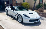 White Corvette C7 with custom 20-inch black and white rims parked in a driveway.