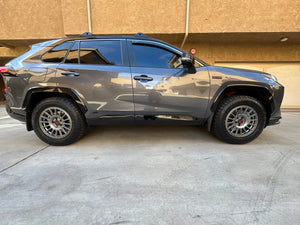 Full side profile of a grey 2024 Toyota RAV4 Prime on RVRN RV-MT117 matte gunmetal forged wheels with all-terrain tires