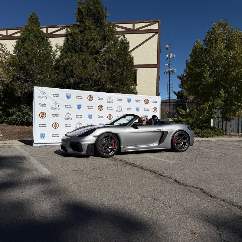 Porsche owner proudly posing with his car during the event.