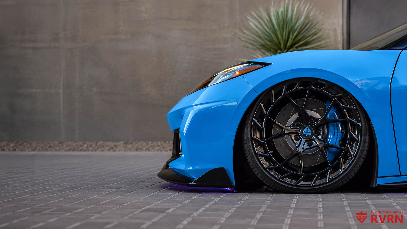 Blue corvette sportscar with black rvrn forged rims on a paved surface