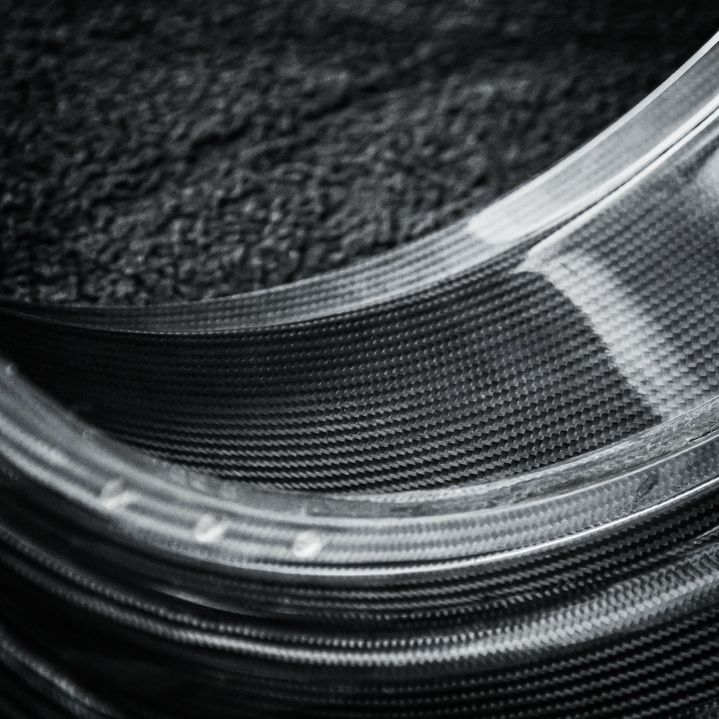 Close-up of carbon fiber material with a textured surface
