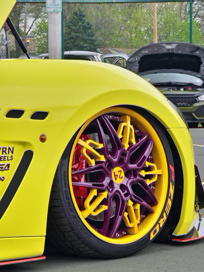 Angled shot of Maserati custom wheels with yellow and purple finish, custom forged wheels design option